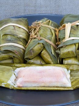 Glutinous rice with banana and peanut steamed in banana leaf - Thai traditional food