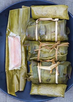 Glutinous rice with banana and peanut steamed in banana leaf - Thai traditional food