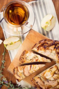 apple pie, with an cut piece and cup of tea