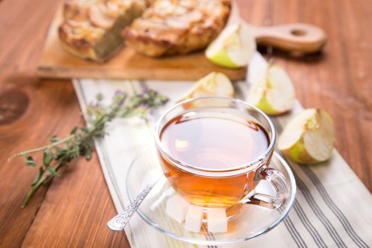 apple pie, with an cut piece and cup of tea