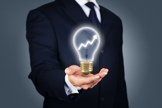 Businessman with a light bulb with rising chart