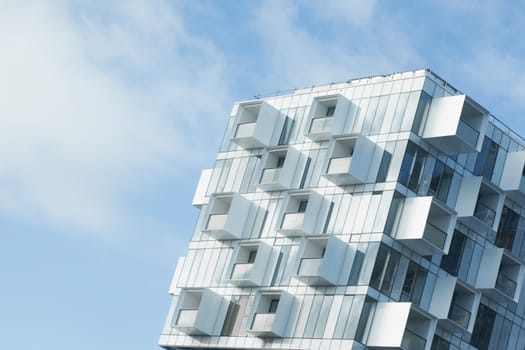 White abstract background of a modern apartment building with balconies