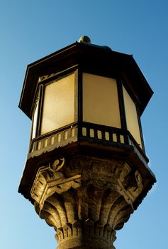 Obsolete Decorative Street Lantern with Forging Details on Blue Sky background Outdoors