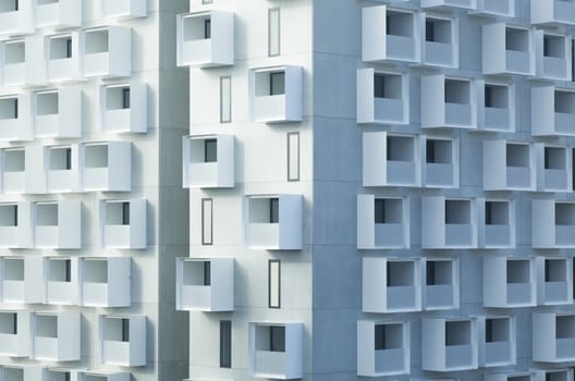 White abstract background of a modern apartment building with balconies