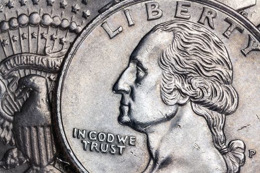 Close-up detail on a United States quarter dollar coin - In God we Trust - Liberty.