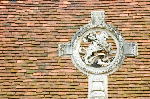 st george and the dragon monument against a tiled roof background