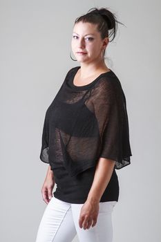 mid-30 woman with transparent shirt and white pants