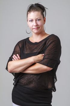 Woman in her mid-thirties with her arms cross