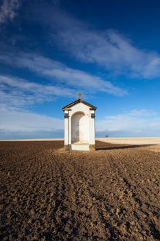 A small chapel in the middle of autumn fields