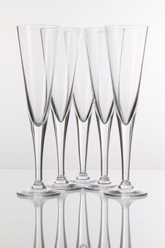 Five champagne glasses on a glass plate