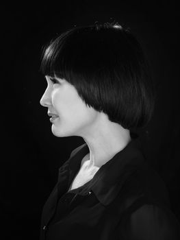 Black and white image of beautiful woman profile on black background