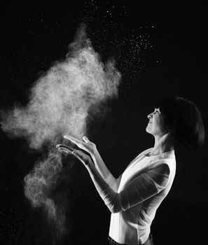 Black and white image of young woman with smoke