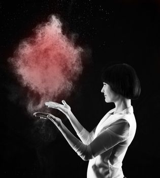Black and white image of woman with red abstract smoke heart on black background
