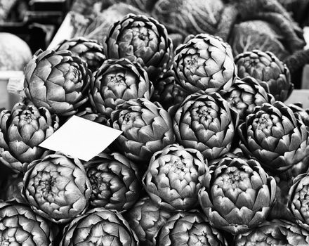 Black and White image of artichokes at street market