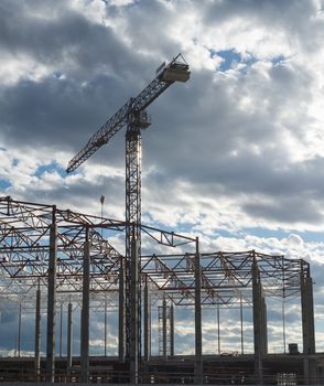 Construction site. Framework of the new building and tower crane above it.