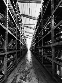Black and White image of warehouse shelves with tools