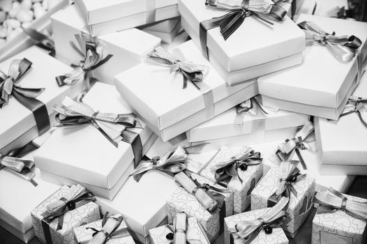 Black and white image of gifts pile with ribbons