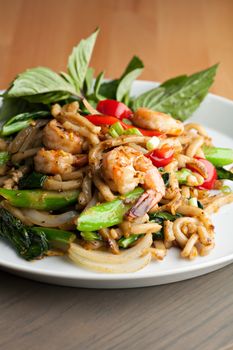 Thai food shrimp stir fry with lo mein noodles Shallow depth of field.