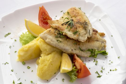 Tilapia fillet with lemon ,tomatoes and potatoes.