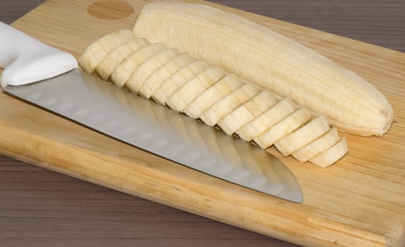 Delicious sliced banana in a dish over a table