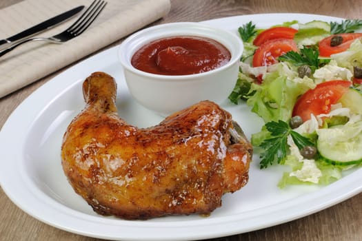 Baked chicken thigh with sauce and salad