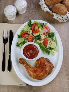 Baked chicken thigh with sauce and salad