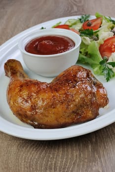 Baked chicken thigh with sauce and salad