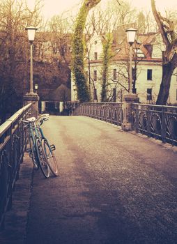 Retro filtered bicycles on a bridge in winter in a European city