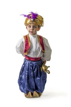 Child in sultan costume with lamp 
on white
