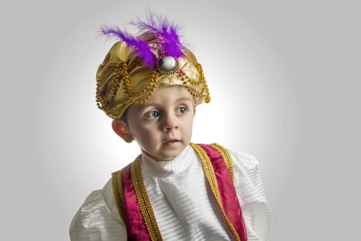 Child posing in sultan costume
