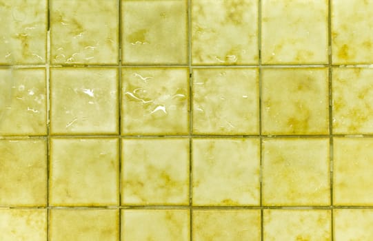 water on old yellow floor tiles .