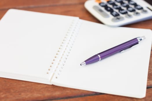 Blank notebook with pen on wooden table, stock photo
