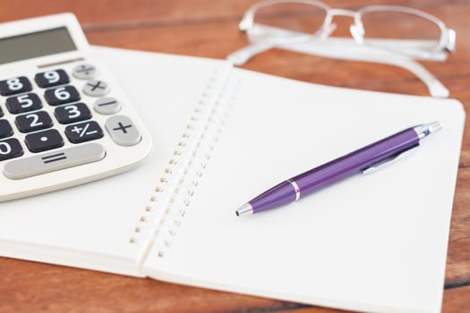 Blank notebook with pen on wooden table, stock photo