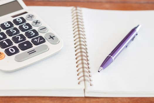 Blank notebook with pen on wooden table, stock photo