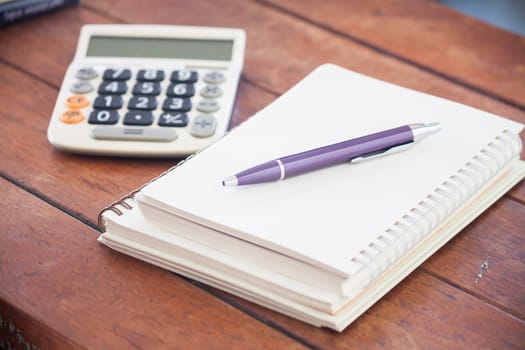 Blank notebook with pen on wooden table, stock photo