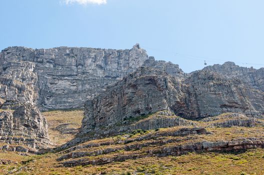 View of Table Mountain and upper cable station in Cape Town. A cable car is visible. The cableway was opened on October 4, 1929
