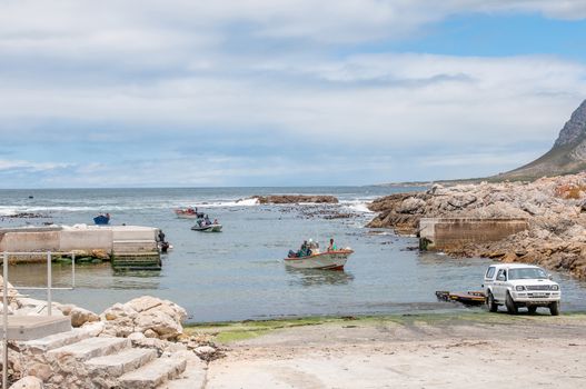 KLEINMOND, SOUTH AFRICA - DECEMBER 23, 2014: Crayfish boats arriving at the harbor to be pulled out of the water
