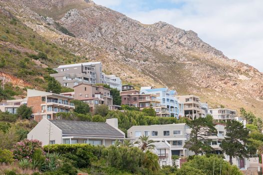 CAPE TOWN, SOUTH AFRICA - DECEMBER 20, 2014: Luxury homes against the Hottentots Holland Mountains in Gordons Bay near Cape Town. 
