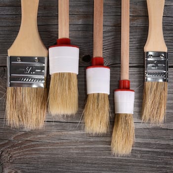 The paint brush on a wooden background