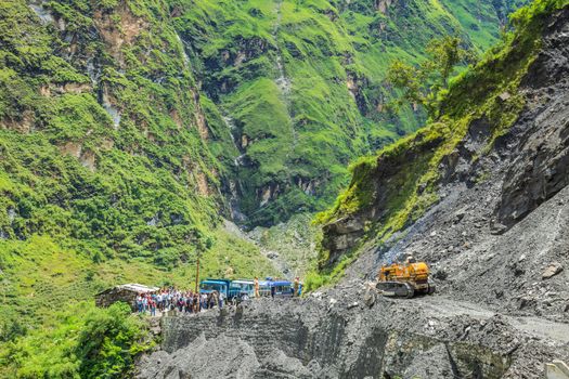 Govinghat, India - Aug 9 : The officer from Indian Highway Department clear the road that was blocking after landslide on August 9, 2014 in Govinghat, India