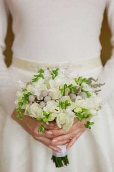 Beautiful wedding bouquet in hands of the bride