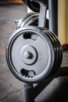 Gym interior with barbell plates holder rack