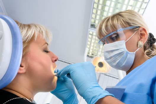 dentist at work with patient, dental exam, polishing and finishing