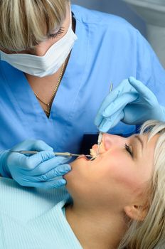 dentist at work with patient, dental exam, polishing and finishing
