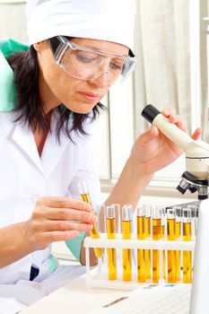 female scientist microscoping in the life science research laboratory (genetics, biochemistry, forensics, microbiology) 