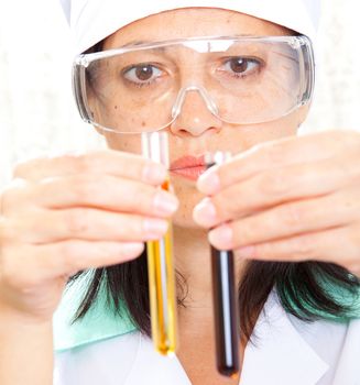 Closeup of a female scientist filling test tubes