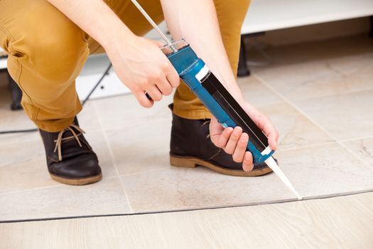 worker repairing the floor, pert of body