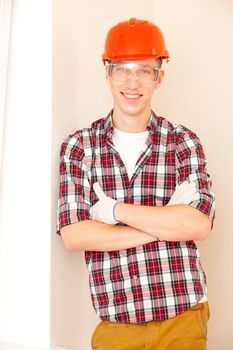 young smiling construction worker in new apartment