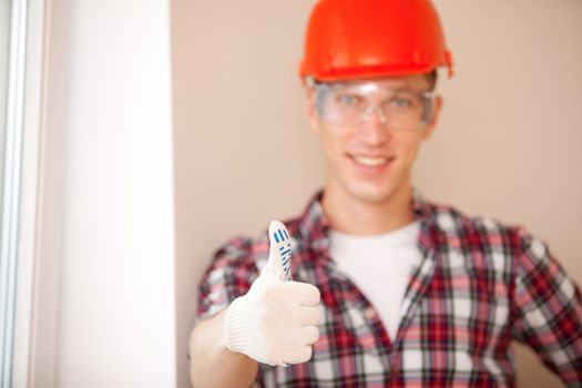 shot of young construction worker with thumbs up