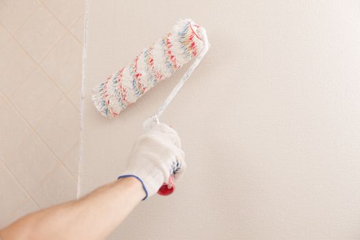 wall painting roller and human hand